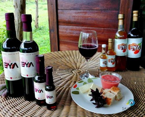 a table with wine bottles and a plate of food at EYA Ecolodge in San Isidro