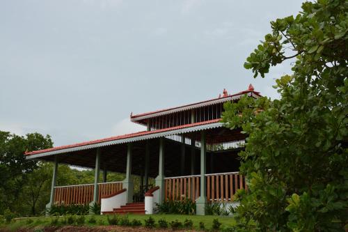 a large building with a red roof and stairs at Porsu in Canacona