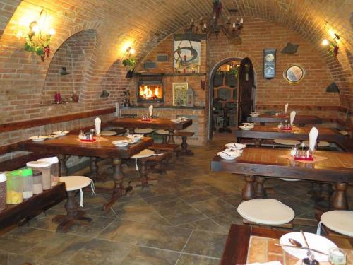 a restaurant with wooden tables and a fireplace at Chata Salma Jeseníky in Dolní Moravice