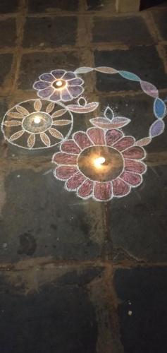 a rangoli of flowers on the floor at OmBodhi Retreat in Kumta