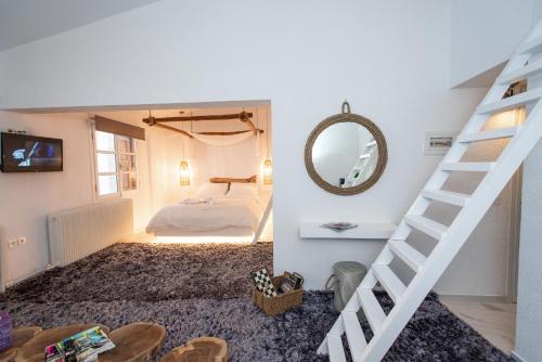 a room with a staircase and a bed and a mirror at Blue Mountain Guesthouse by Seablue in Arachova