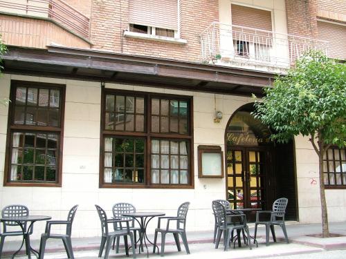 a group of tables and chairs in front of a building at Hotel Ciudad De Calahorra in Calahorra