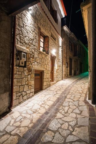 an empty street in an old stone building at night at Blue Mountain Guesthouse by Seablue in Arachova