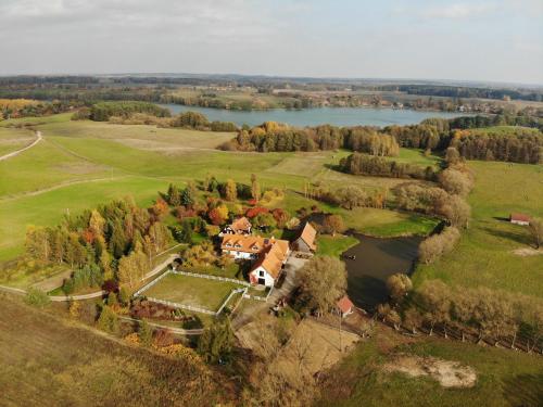 an aerial view of a house and a lake at Andrzejówka in Borowe
