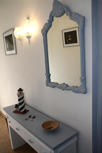 a dressing table with a mirror on a wall at VISTAS PRIVILEGIADAS in Palamós