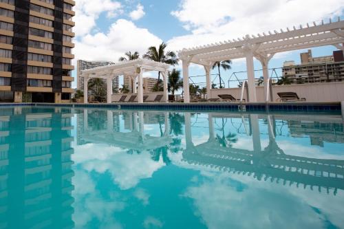 a pool at a hotel with a gazebo at Waikiki Monarch Hotel in Honolulu