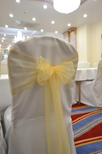 a white wedding dress with a yellow bow on it at Best Western Greater London in Ilford