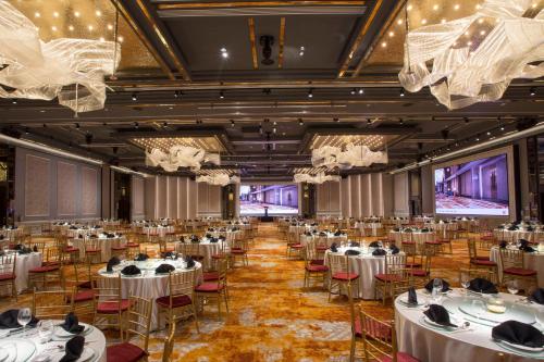 a banquet hall with white tables and chairs at Orchard Hotel Singapore in Singapore