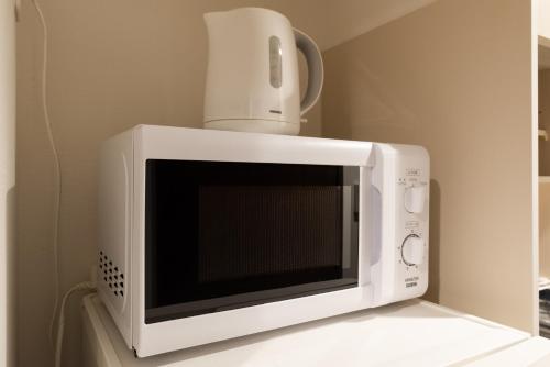 a white microwave with a drone on top of it at Dash Living Higashi Azabu in Tokyo