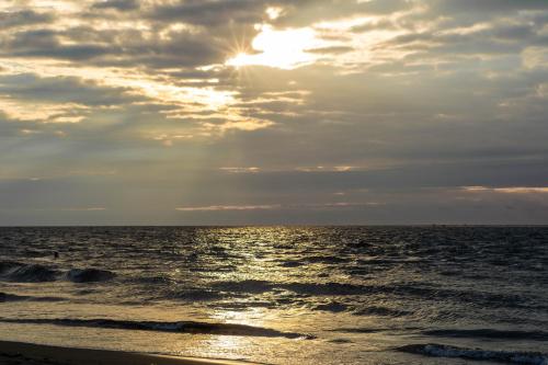 a sun setting over the ocean on a beach at Hotel & Resort Villa del Sol in Tumaco