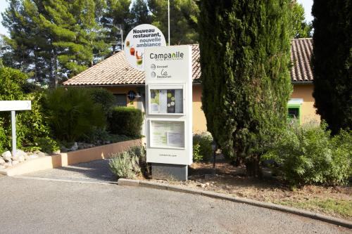 a sign in front of a house in a yard at Campanile Manosque in Manosque