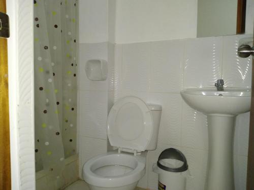 a small bathroom with a toilet and a sink at BACHÍG Hospedaje in Moyobamba