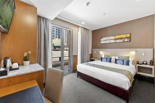 a hotel room with a bed and a desk at YEHS Hotel Sydney QVB in Sydney