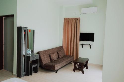 a living room with a couch and a table at OK FAMILY VILLA in Ipoh