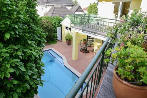 an overhead view of a house with a swimming pool at On Pinewood Guest House in Cape Town