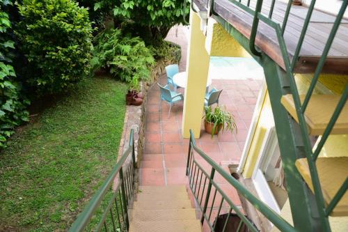 a balcony with two chairs and a table on a patio at On Pinewood Guest House in Cape Town