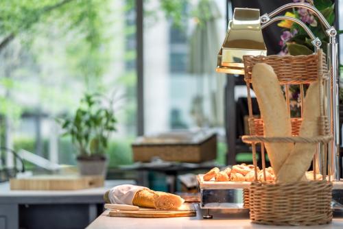 a table with a basket of bread and pastries at Sivatel Bangkok Hotel in Bangkok