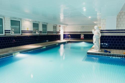 a swimming pool with a statue in the middle of it at Crown Spa Hotel Scarborough by Compass Hospitality in Scarborough
