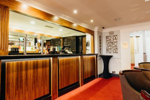 a bar in a hotel room with a mirror at Crown Spa Hotel Scarborough by Compass Hospitality in Scarborough