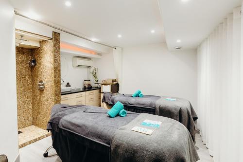a room with three beds in a room with a kitchen at Crown Spa Hotel Scarborough by Compass Hospitality in Scarborough