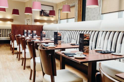 a row of tables and chairs in a restaurant at Crown Spa Hotel Scarborough by Compass Hospitality in Scarborough
