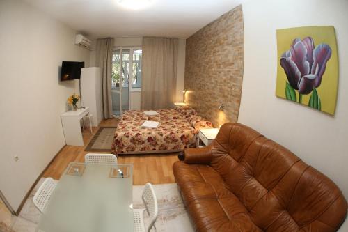 a bedroom with a bed and a couch in a room at COLORED HOUSE Apartments in Sofia