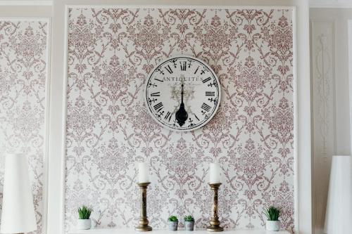a clock is on a wall with a wallpaper at Crown Spa Hotel Scarborough by Compass Hospitality in Scarborough