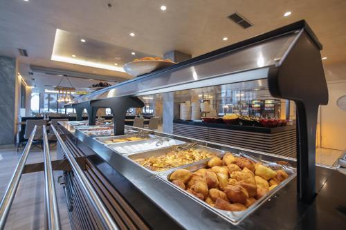 a bakery with a lot of pastries on display at Brilliant Hotel & SPA in Golem