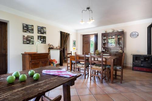 a kitchen and dining room with a table and chairs at Cottage l'Assiolo in Branca