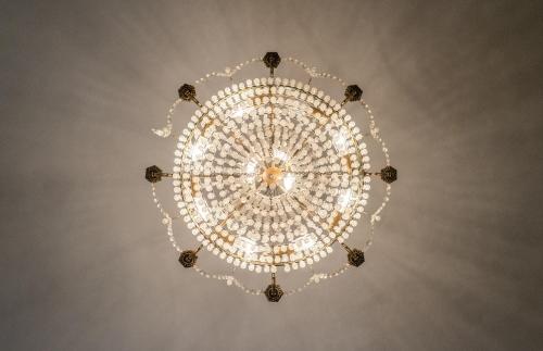 a large chandelier hanging from a ceiling at Stadshotellet Kristianstad in Kristianstad
