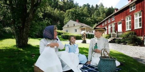 a group of people sitting on the grass at Gustafsbergs Badhotell & Vandrarhem in Uddevalla