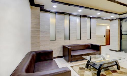 a living room with a couch and a table at Ring View Hotels - Hebbal in Bengaluru