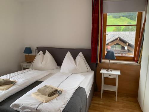 two beds in a room with a window at Dachstein Mountainview Gosau in Gosau
