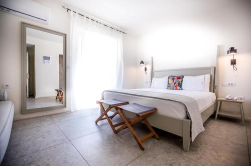 a bedroom with a large bed and a mirror at Lemon Tree House in Karpathos