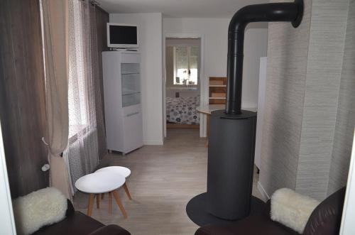 a living room with a black stove in a room at Lodge Hotel Les Rousses in Les Rousses
