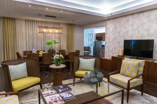 a hotel lobby with a dining area and a television at Movenpick Resort & Spa Boracay in Boracay
