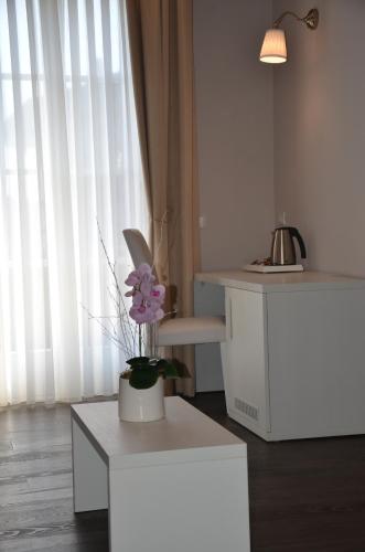 a room with a vase of flowers on a table at H2o in Sirmione
