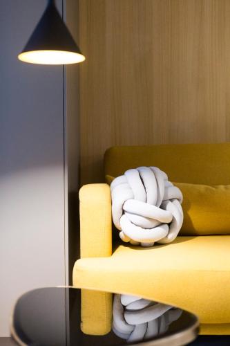 a pile of white towels on a yellow couch at Kabia by Smiling Rentals in Hondarribia