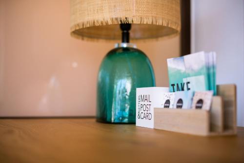 a green lamp sitting on top of a table at TAKE SURF Hostel Conil in Conil de la Frontera