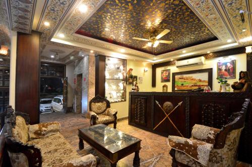 a living room with a coffered ceiling and a table and chairs at Hotel Surya Garh in Jaipur