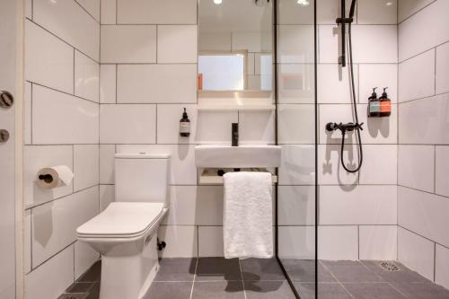 a bathroom with a toilet and a shower at MoMo's Kuala Lumpur in Kuala Lumpur