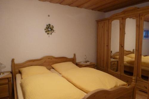 a bedroom with two beds and a mirror at Appartementhaus Osserblick in Lohberg