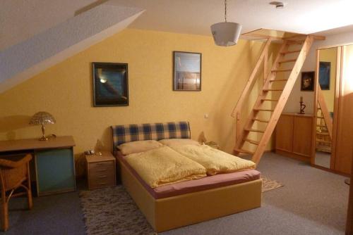 a bedroom with a bed and a stair case at Appartementhaus Osserblick in Lohberg