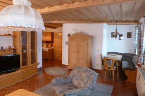 a living room with a couch and a chair and a table at Appartementhaus Osserblick in Lohberg