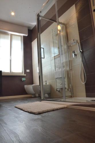 a bathroom with a glass shower and a toilet at H2o in Sirmione