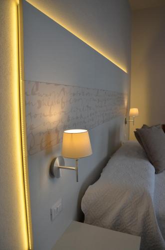 a bedroom with a bed and a mirror at H2o in Sirmione