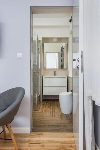 a bathroom with a tub and a toilet and a sink at Żabba in Pobierowo