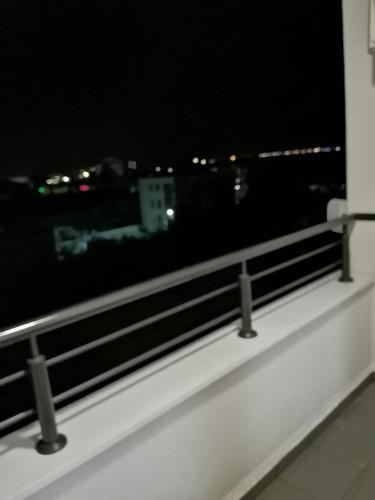 a window with a view of a city at night at Apartman Lux in Nova Pazova
