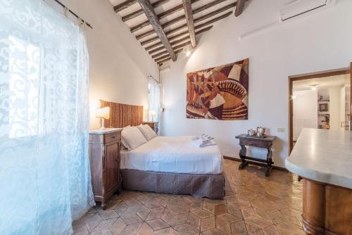 a bedroom with a bed and a table in a room at By the charming Piazza Navona - FromHometoRome in Rome