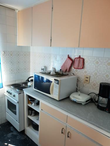 a kitchen with a microwave on a counter at Vendaval 301 in Punta del Este